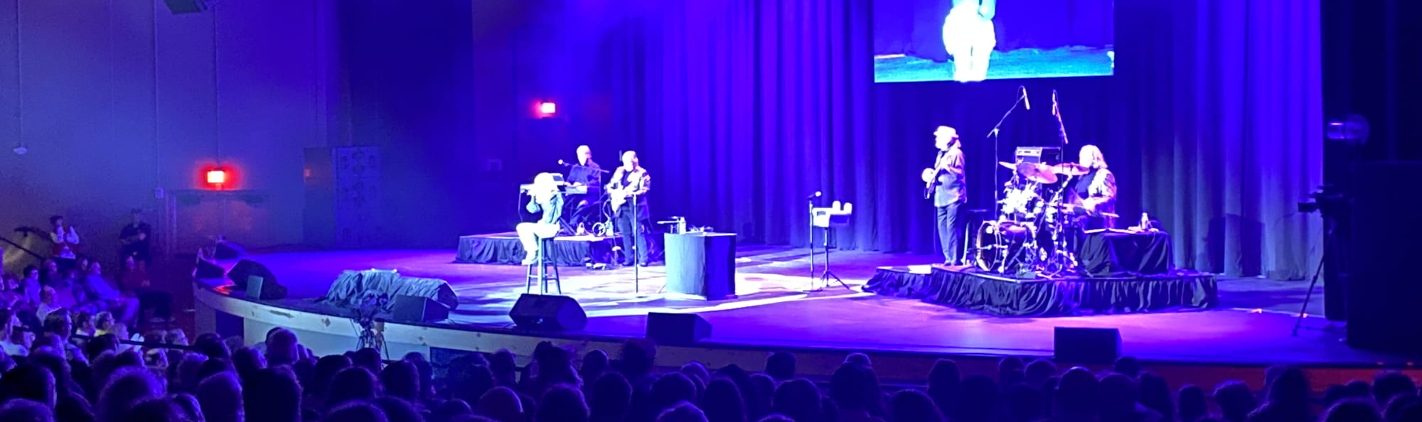 signer on stage in chair washed out by the lights Tallahassee