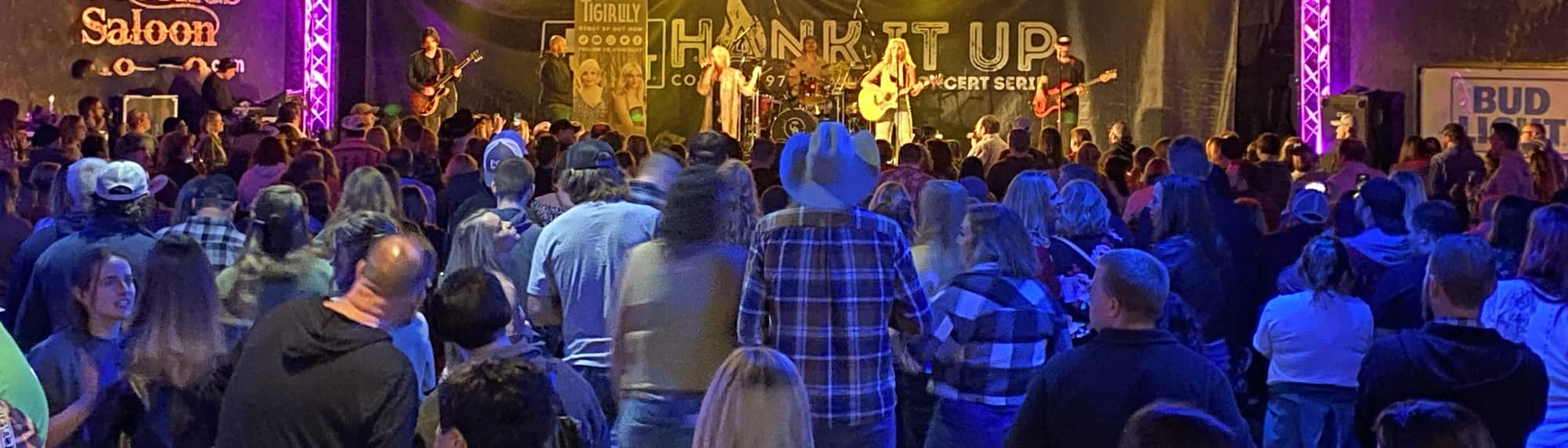 country concert with fans wearing cowboy hats Tallahassee